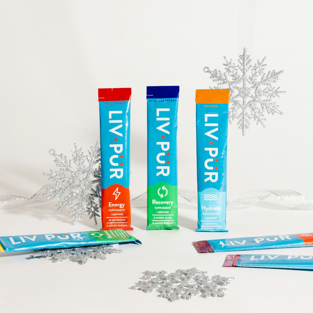 three tubes of toothpaste sitting next to a snowflake