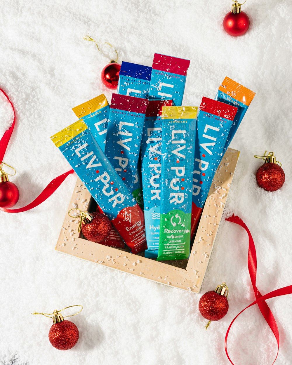 a box of lip butter sitting on top of a snow covered ground