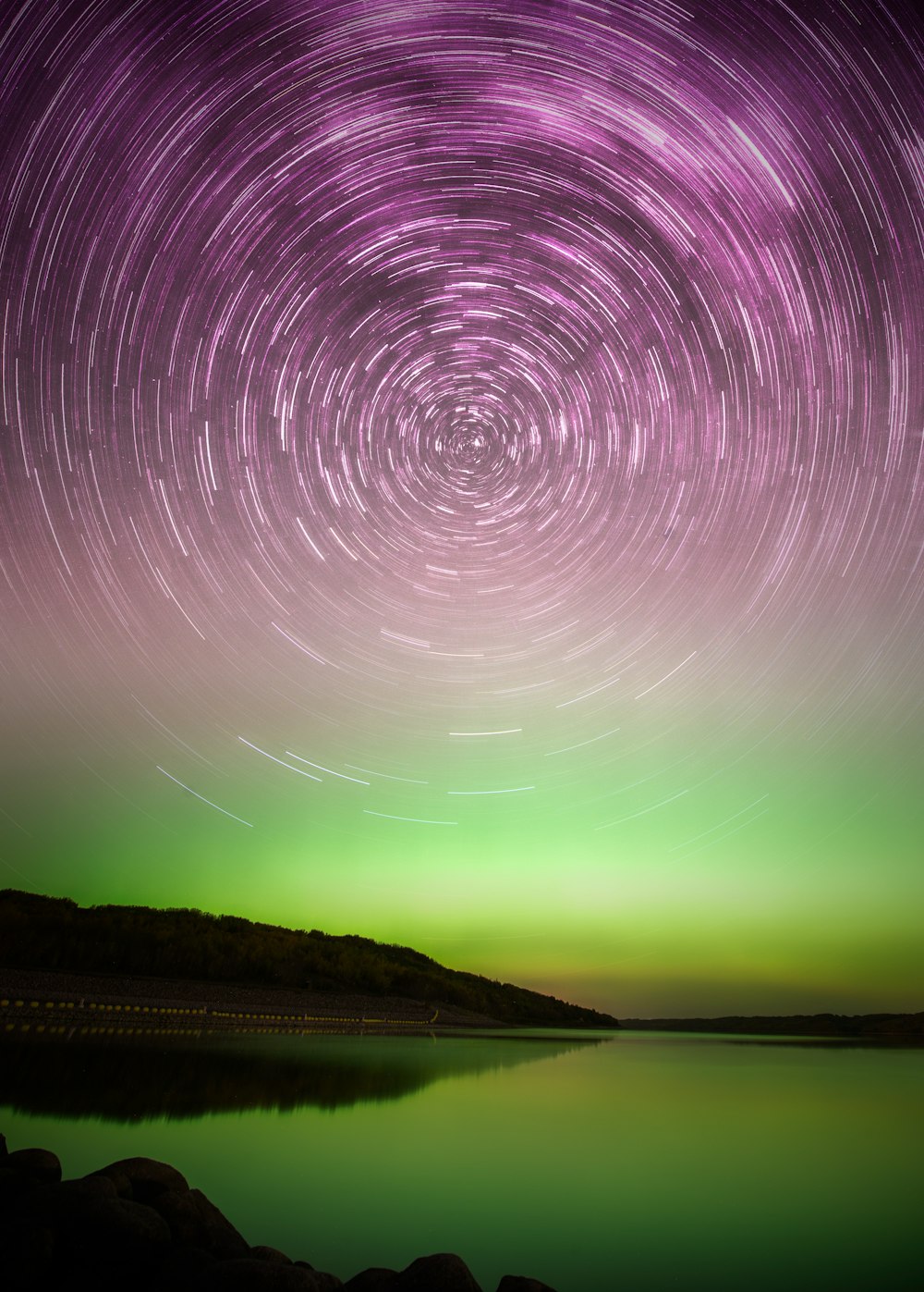 a star trail over a body of water