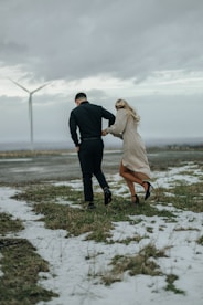 a man and a woman are walking in the snow