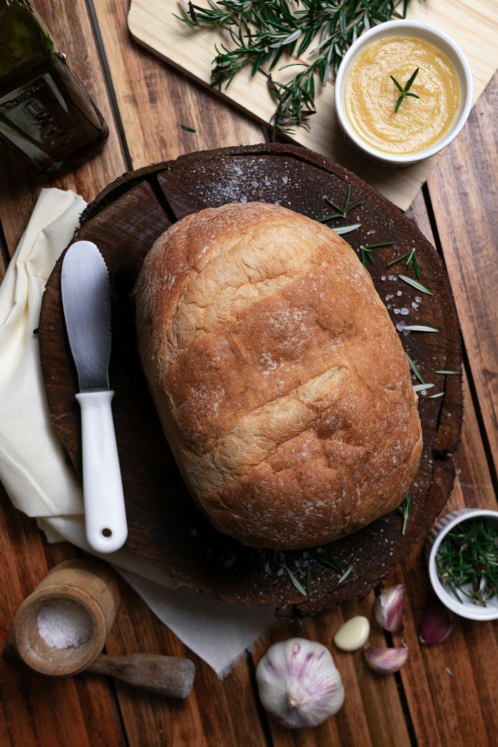 a loaf of bread sitting on top of a wooden cutting board