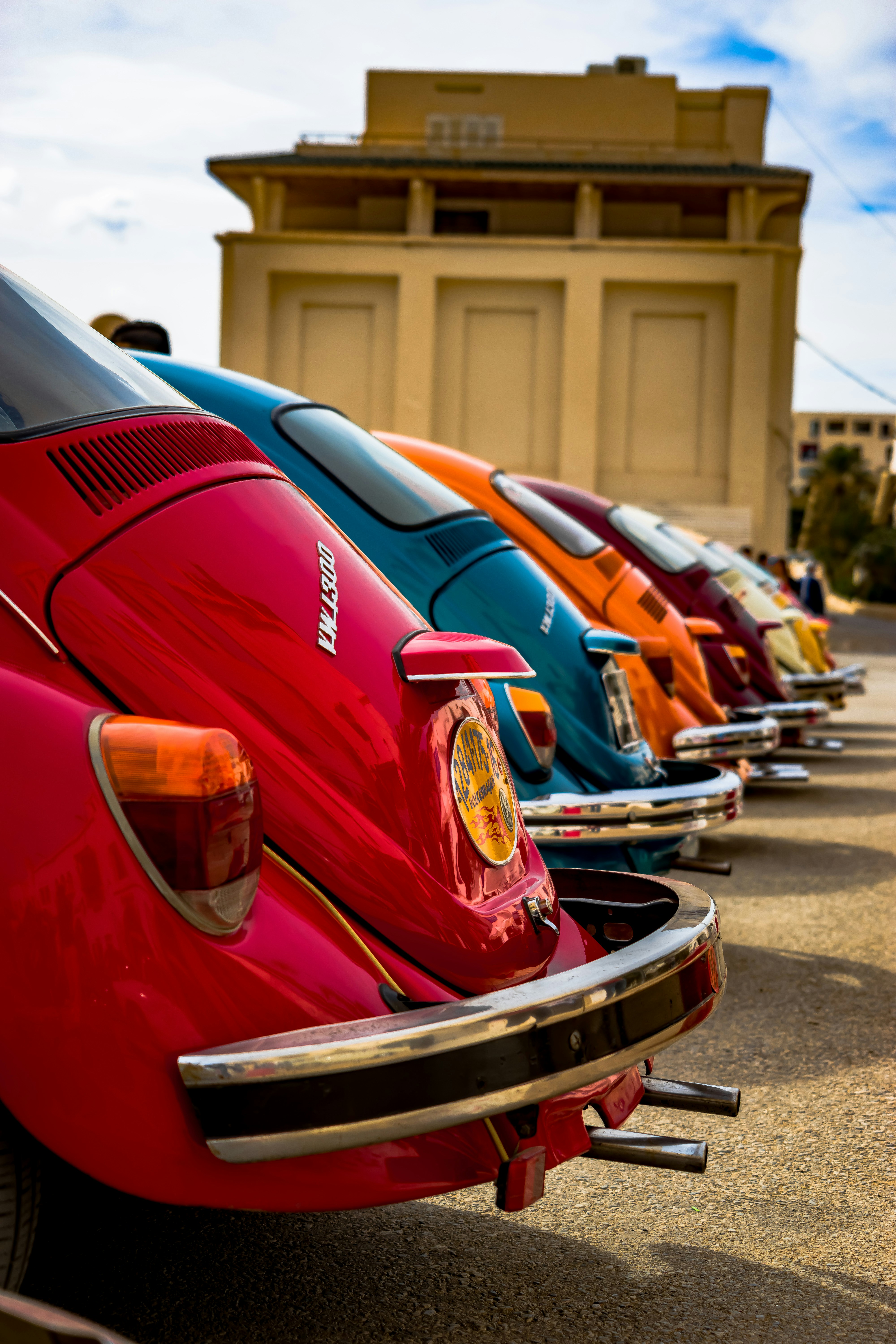 a row of parked cars sitting next to each other