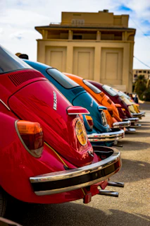 A row of colorful Fuscas lined up outside the workshop, ready for their next drive.