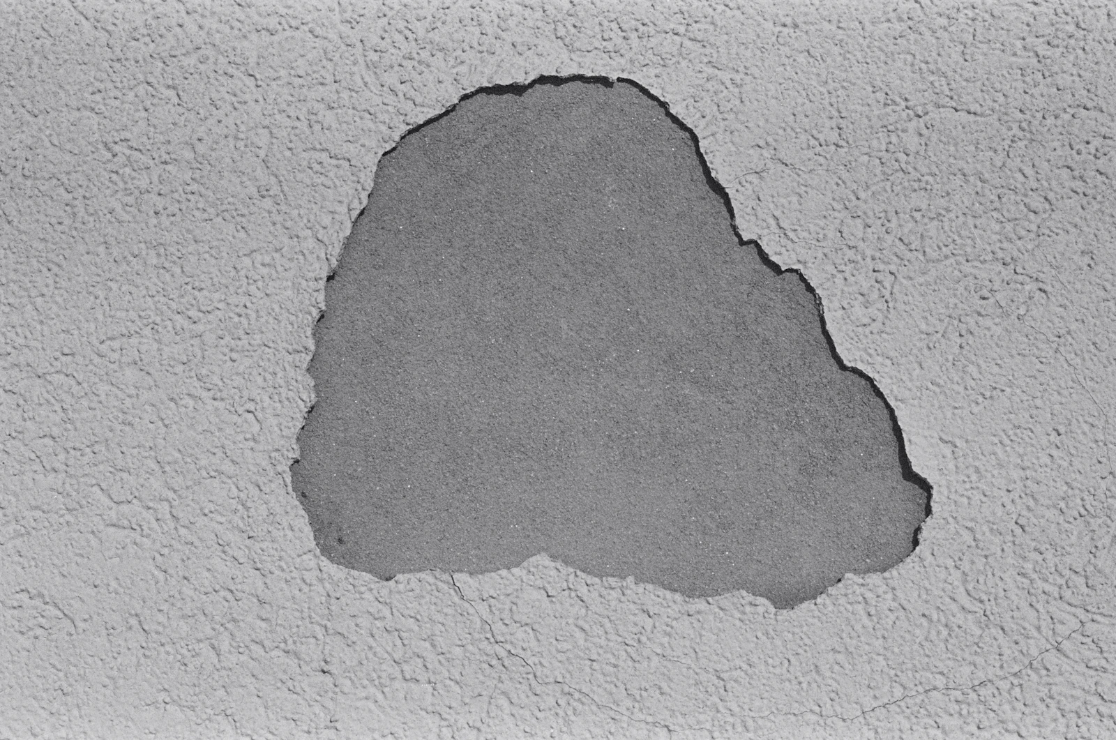 Hairline fracture in concrete surface — minimal architectural detail