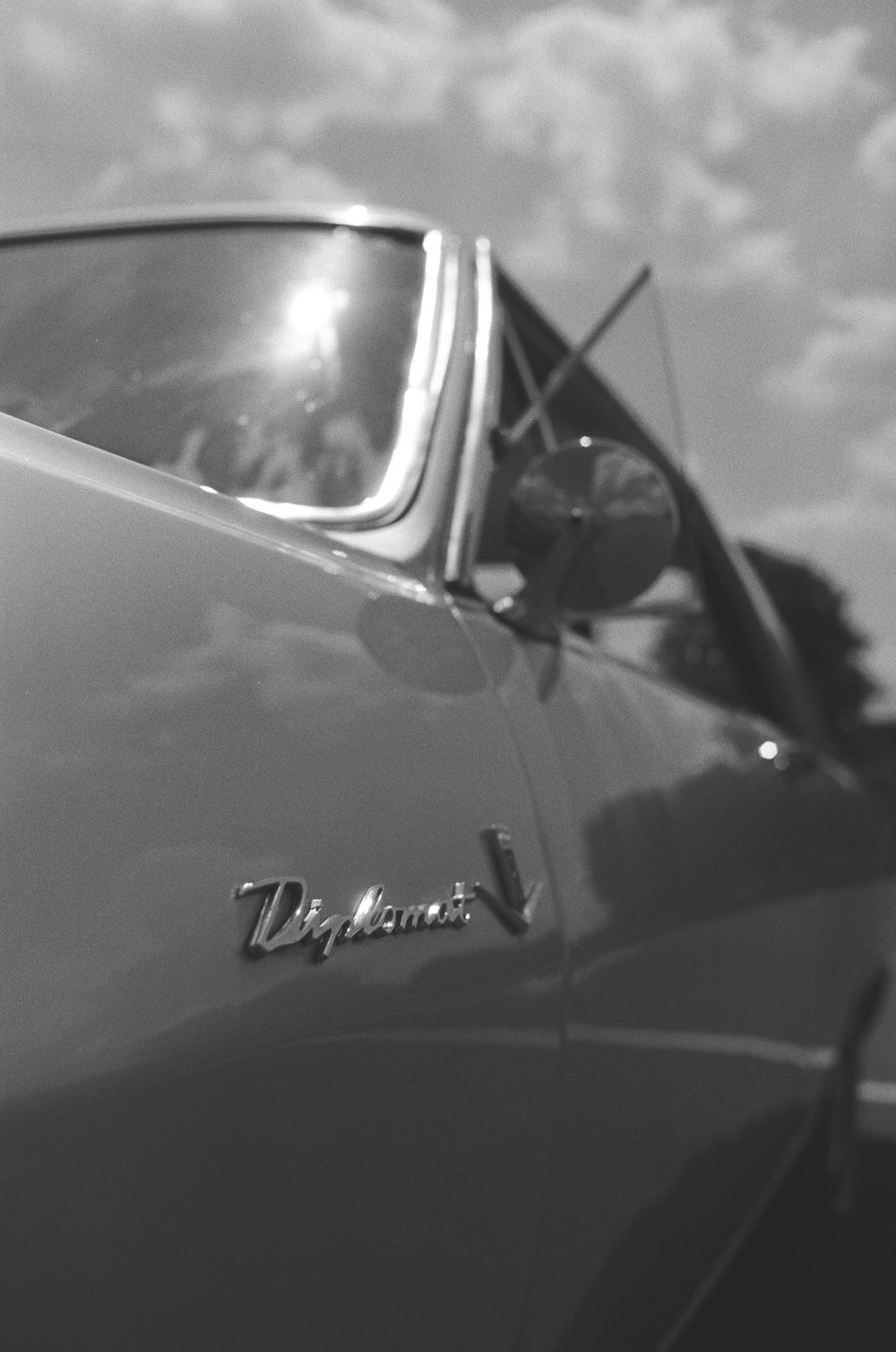a black and white photo of a classic car