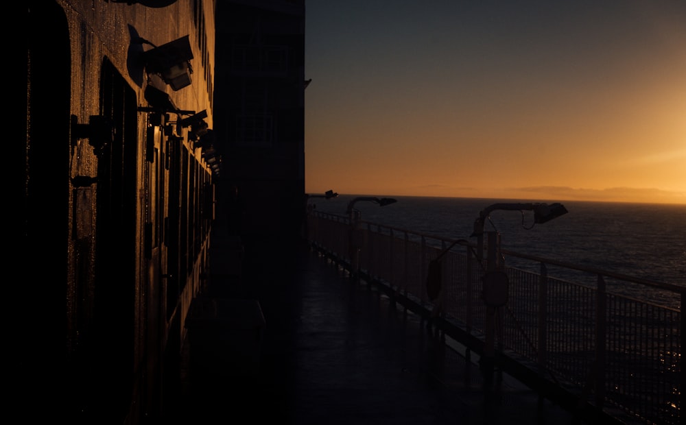 the sun is setting over the ocean as seen from a boat