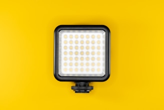 a camera light on a yellow background