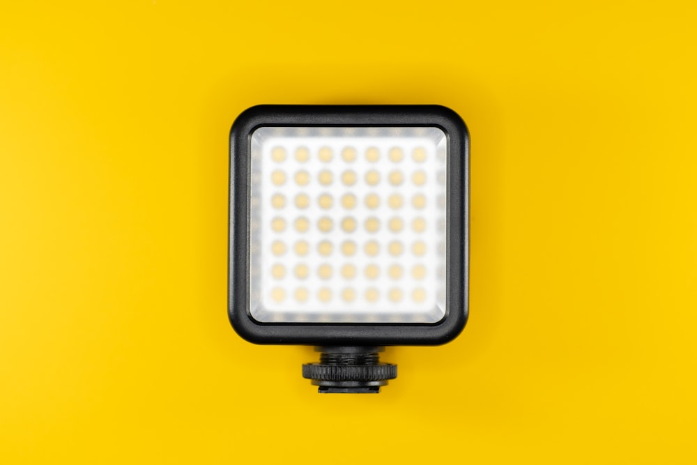 a camera light on a yellow background