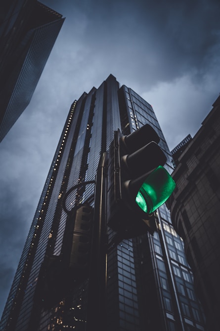a traffic light in front of a tall building