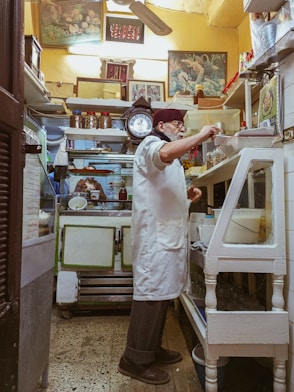 a man standing in a kitchen preparing food