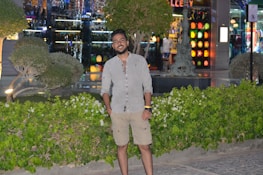 Smiling business owner standing proudly in front of their small shop.