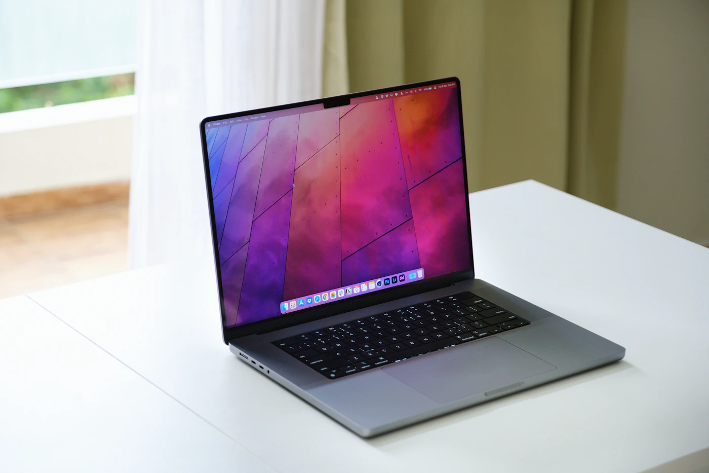 A MacBook open on a bright desk