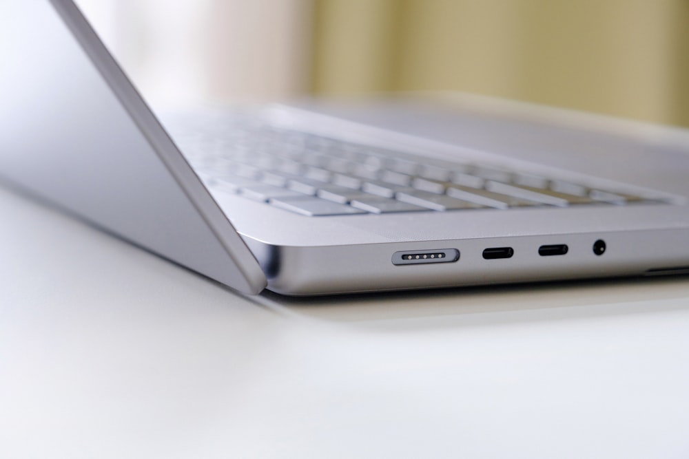 a laptop computer sitting on top of a white table