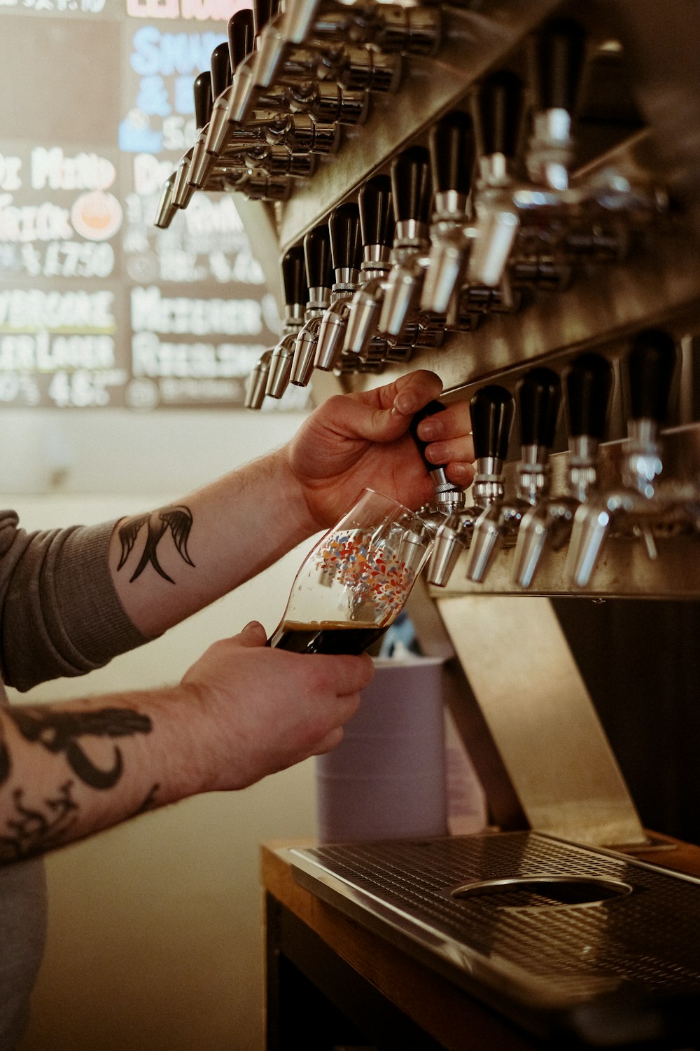 a man is filling a glass of beer