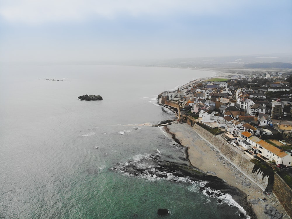 an aerial view of a city next to the ocean