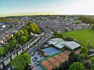 an aerial view of a tennis court in a city