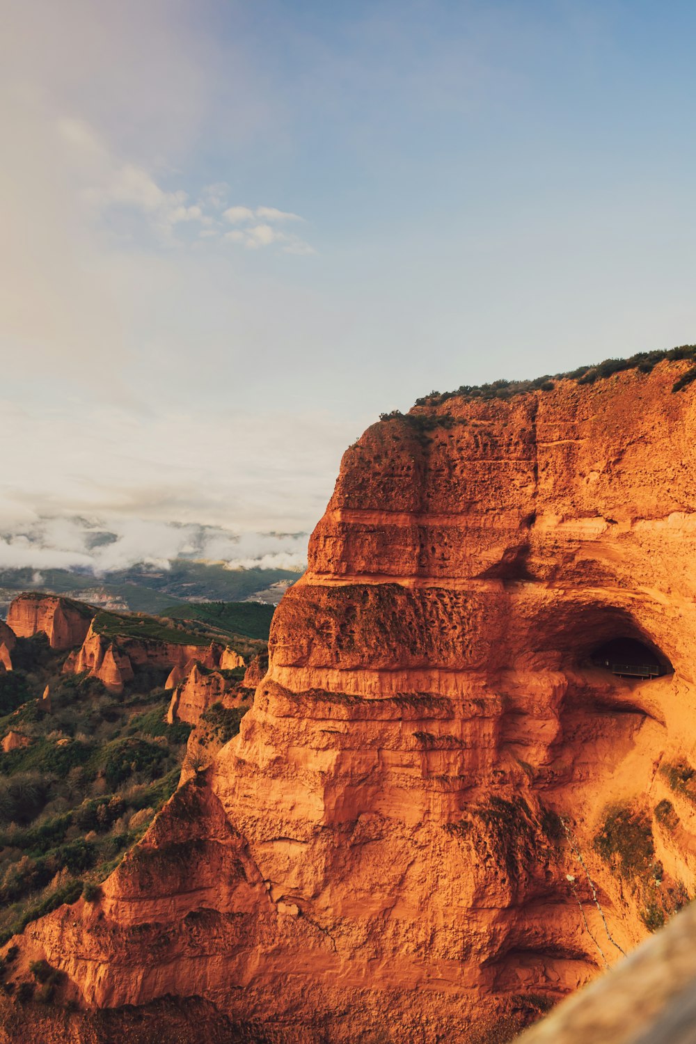 a view of a mountain with a cliff in the background