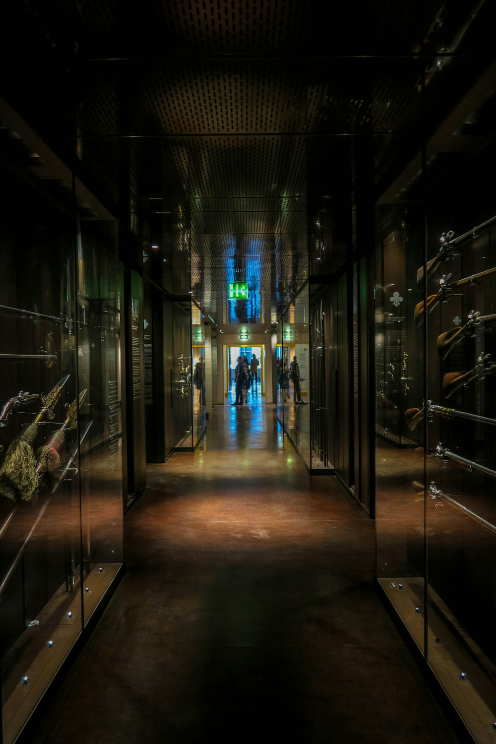 a dark hallway with a lot of glass cases