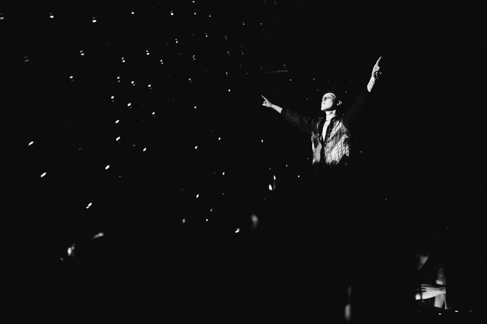 a black and white photo of a man in the dark