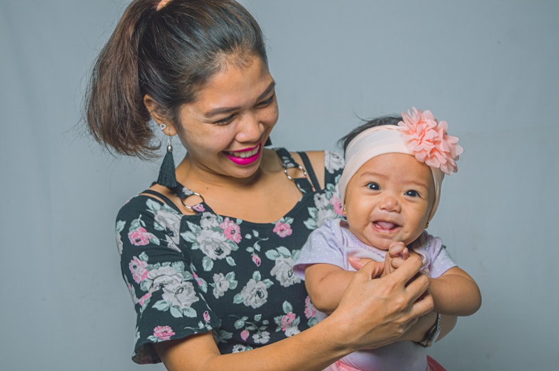 a woman holding a baby in her arms