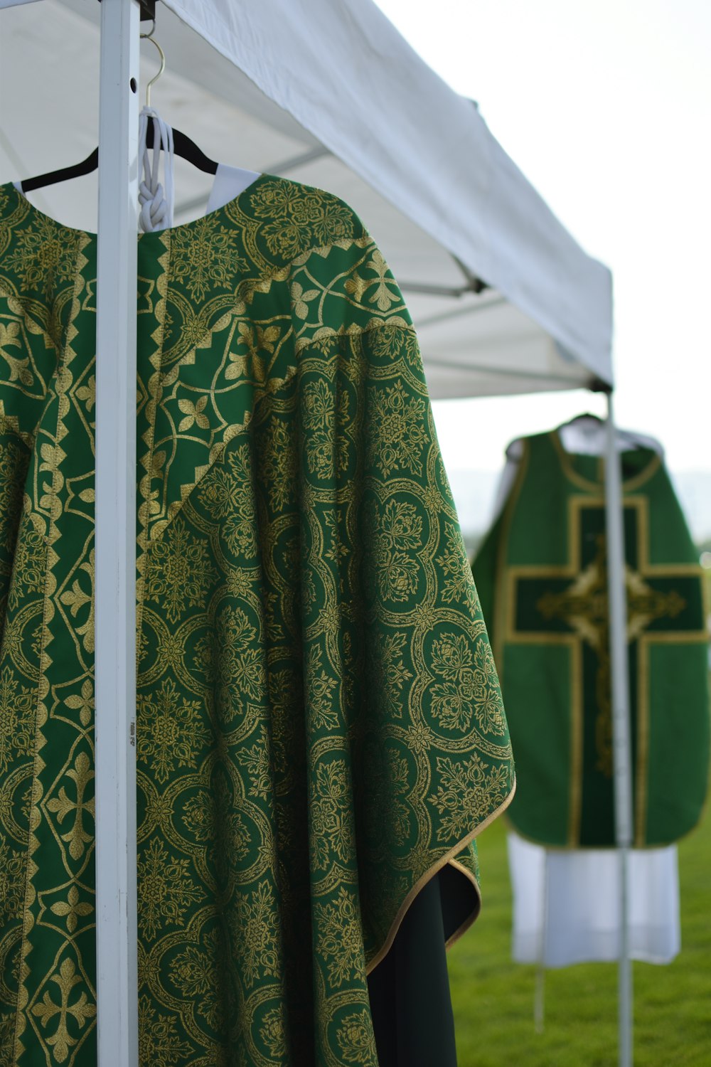 a priest's robe hanging on a white pole