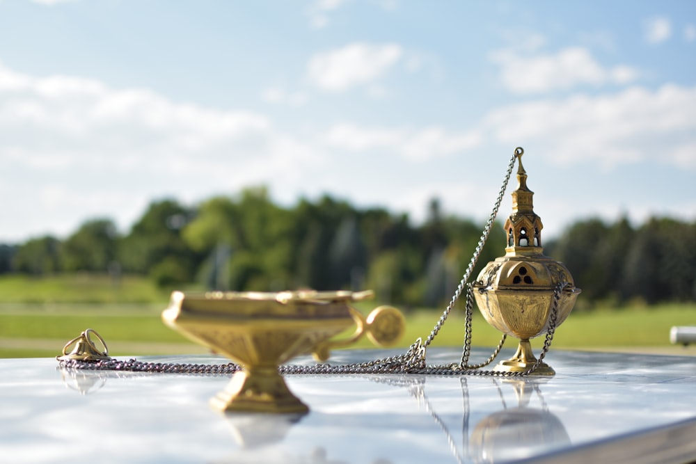 a golden trophy sitting on top of a metal table