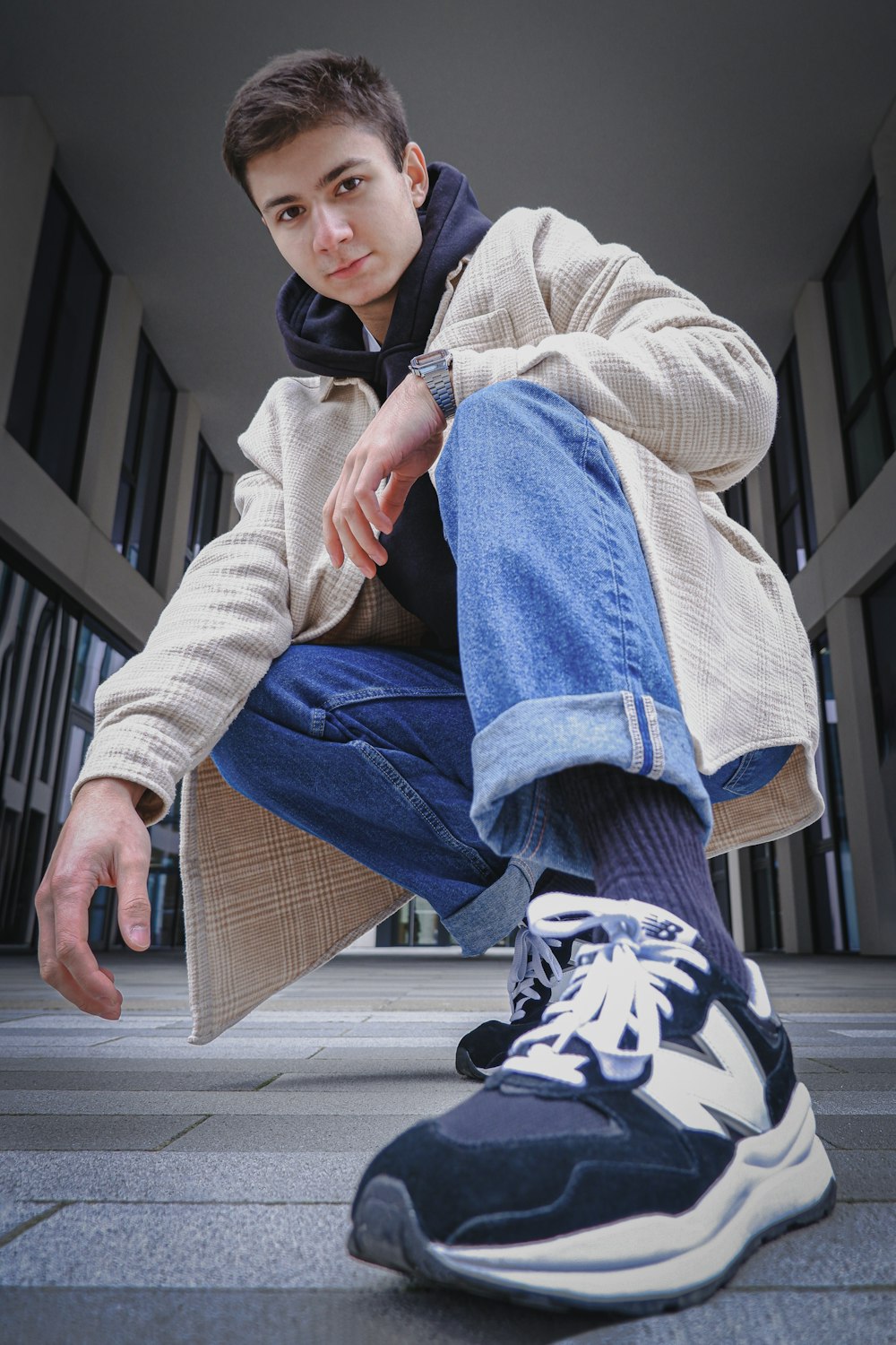 a young man sitting on the ground with his foot on the ground