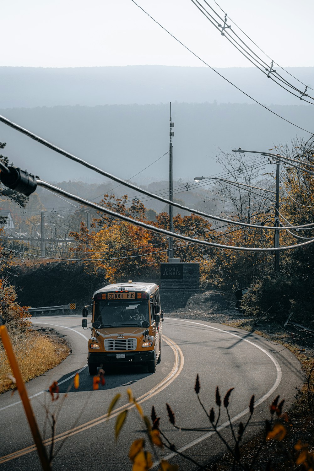 a bus driving down a road next to power lines