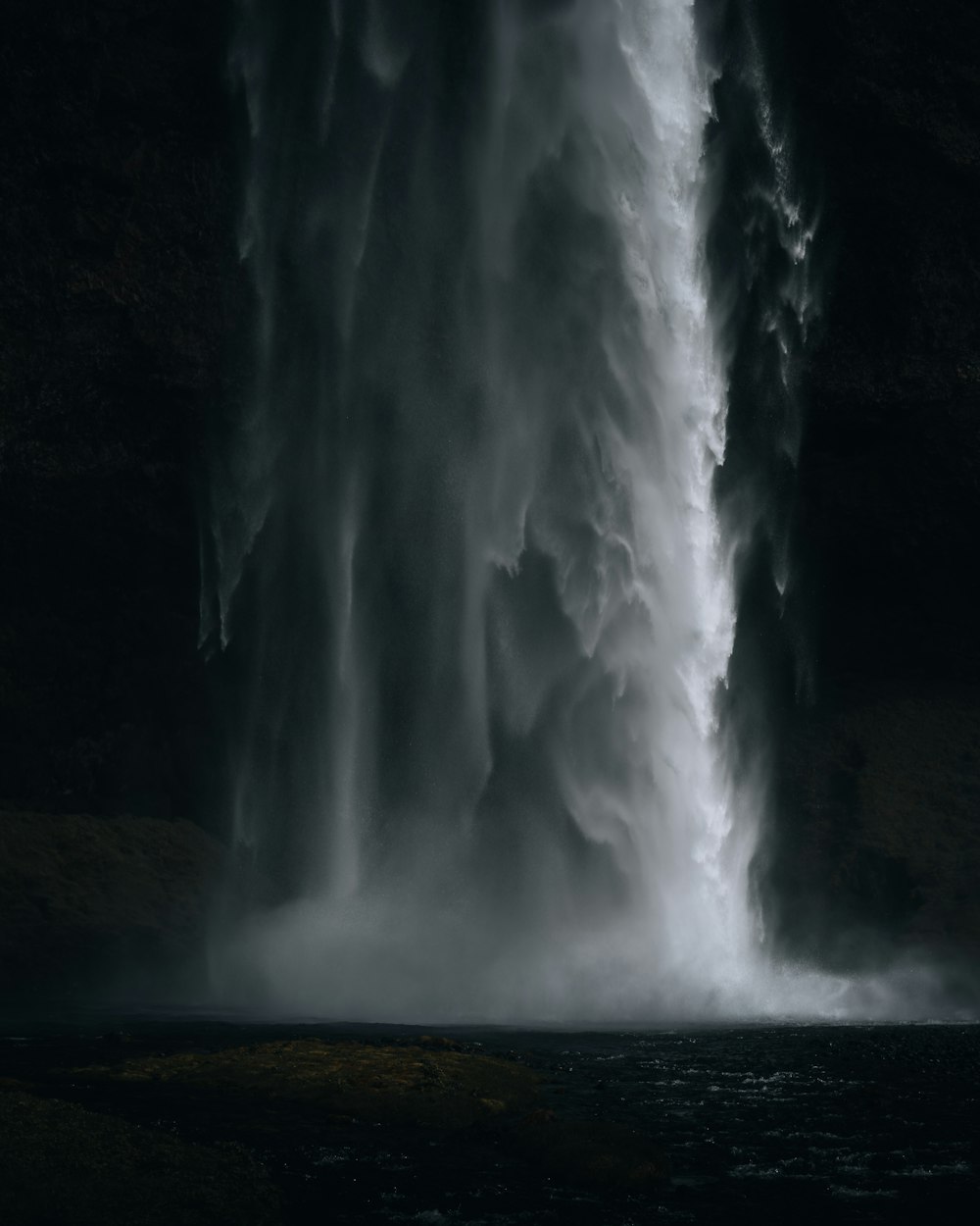 a very tall waterfall with lots of water