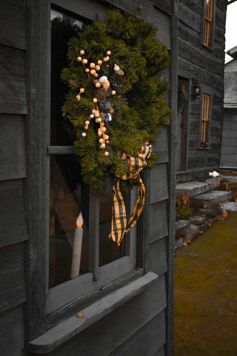 a wreath is hanging on a door of a house