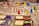 A close-up of a detailed board game in progress with various colored game pieces, such as red, yellow, blue, and green, placed on a textured map. There are also several cards with text and images on them, adding to the intricate and immersive nature of the game.