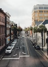 a city street lined with tall buildings and palm trees