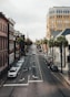 a city street lined with tall buildings and palm trees