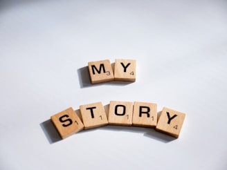 two scrabbled wooden blocks spelling the word my story