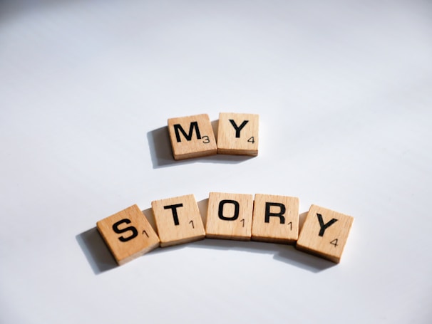two scrabbled wooden blocks spelling the word my story