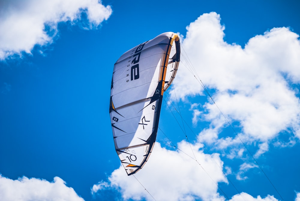 a person is parasailing in the blue sky