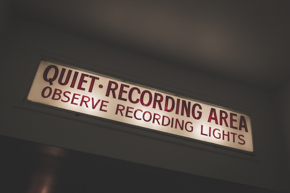 a red and white sign that reads quiet recording area observeive recording lights