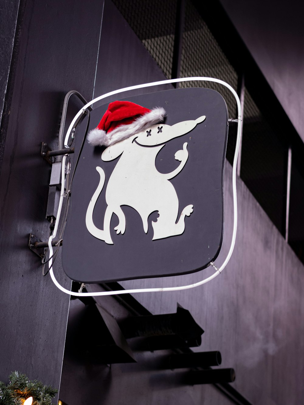 a black and white sign with a santa hat on top of it