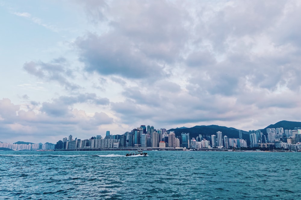 a boat in the water with a city in the background