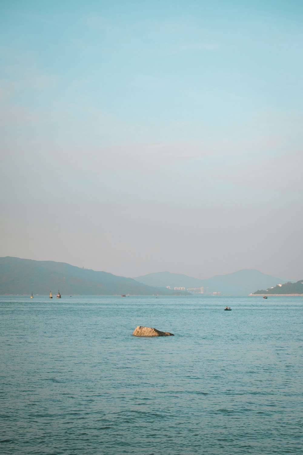 a large body of water with mountains in the background