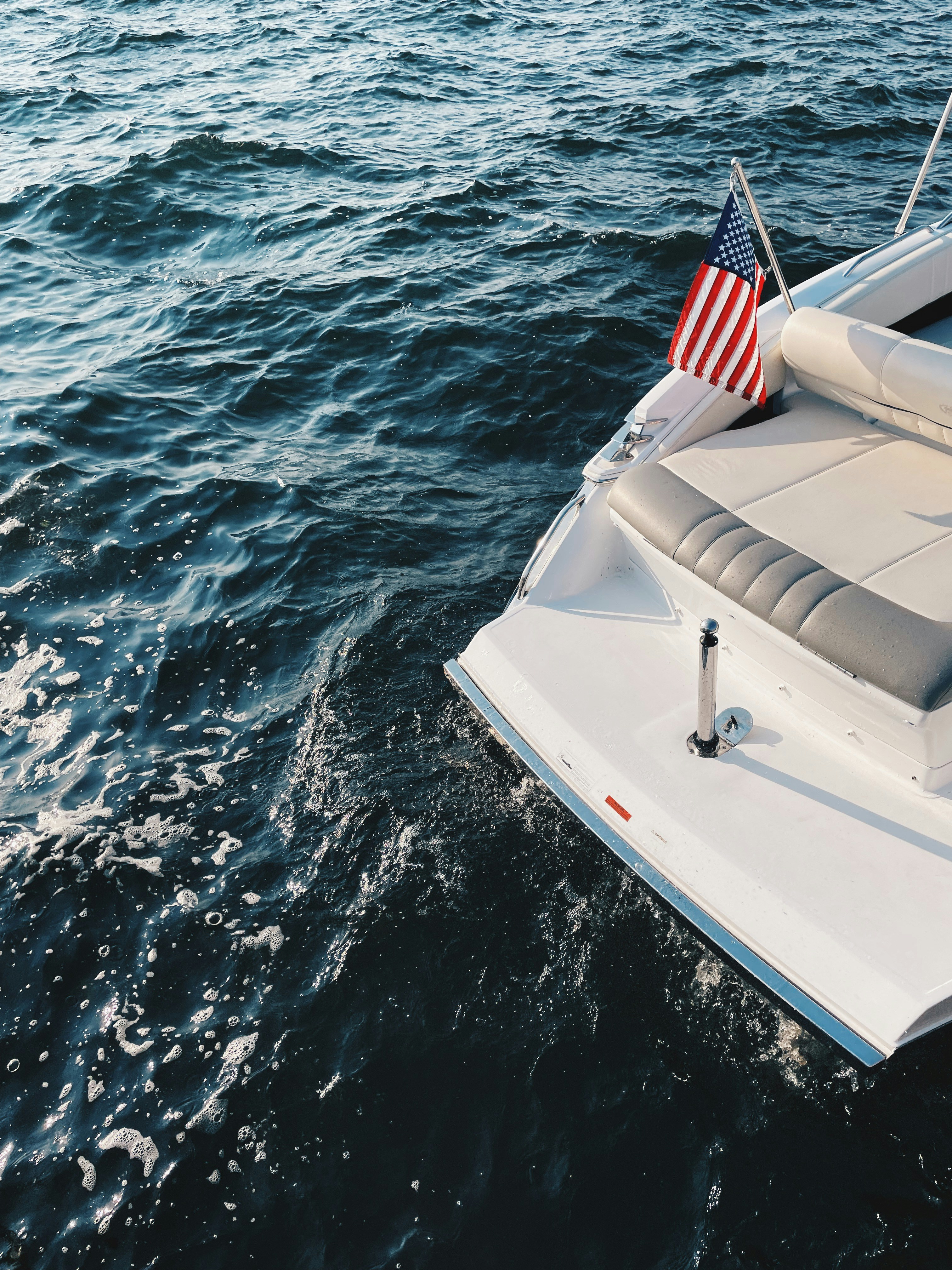 a boat with an american flag on it in the water