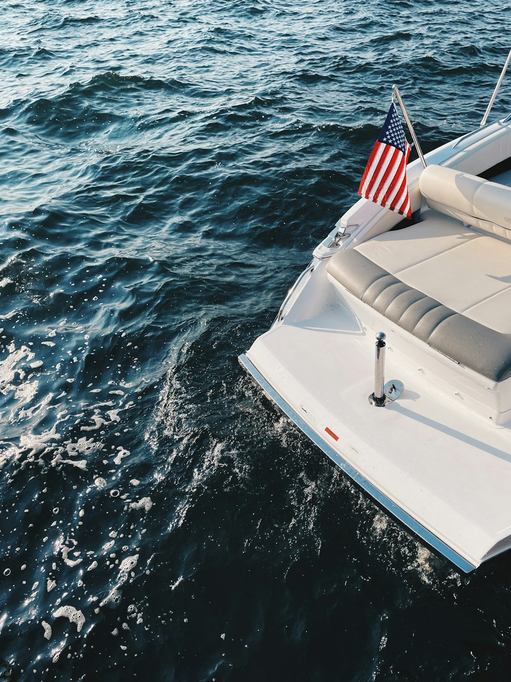 a boat with an american flag on it in the water