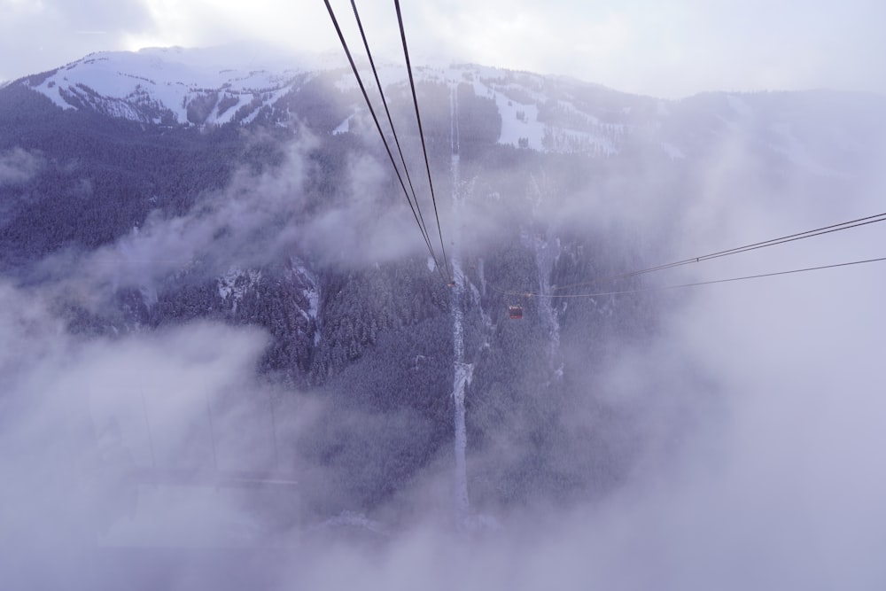 a view of a ski lift in the clouds