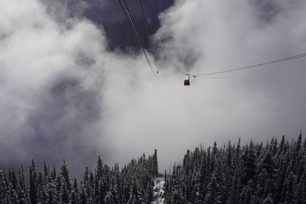 a ski lift going up a snowy mountain