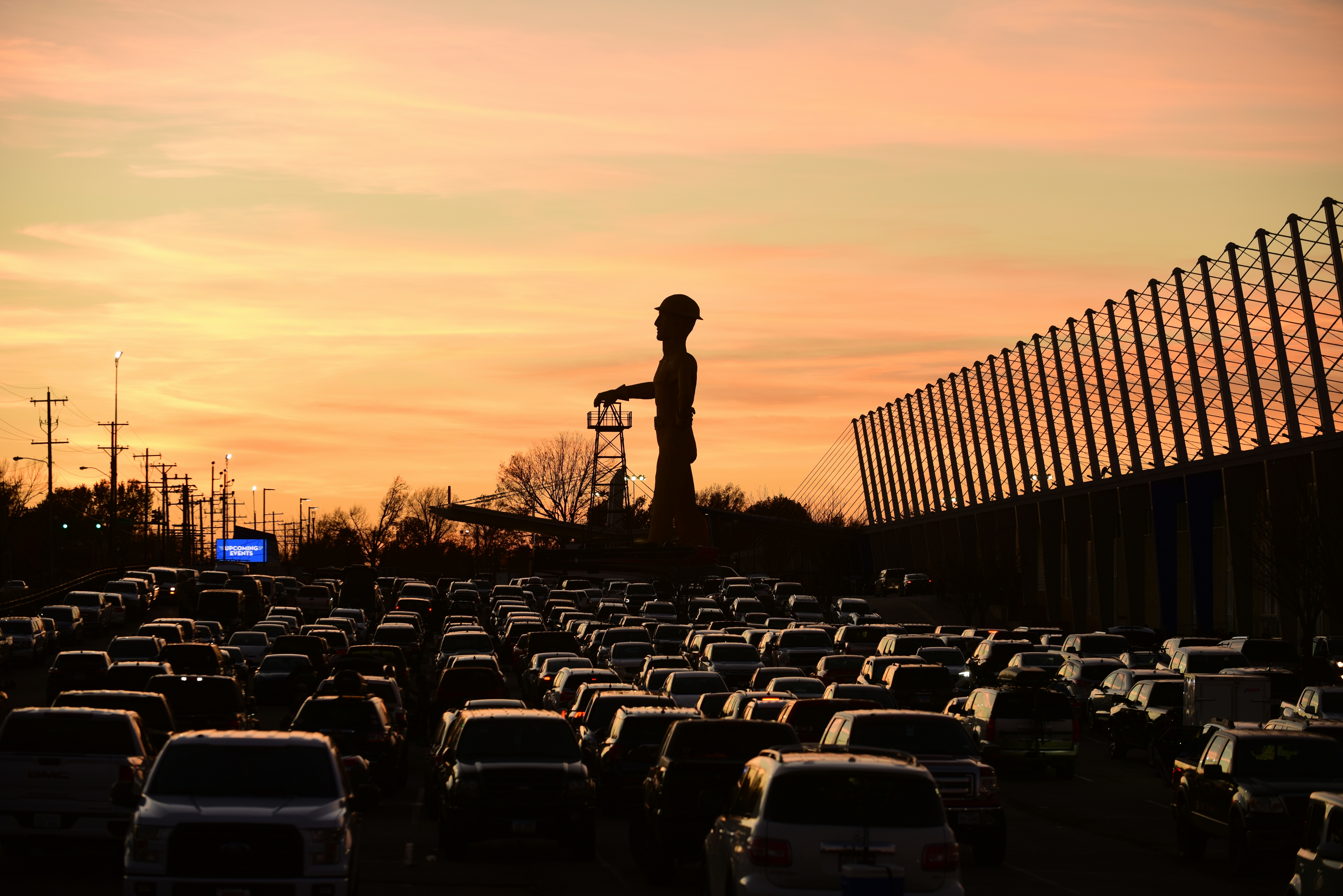 a man standing in the middle of a parking lot