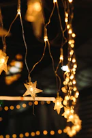 Soft glowing string lights casting a warm ambiance over an evening party.