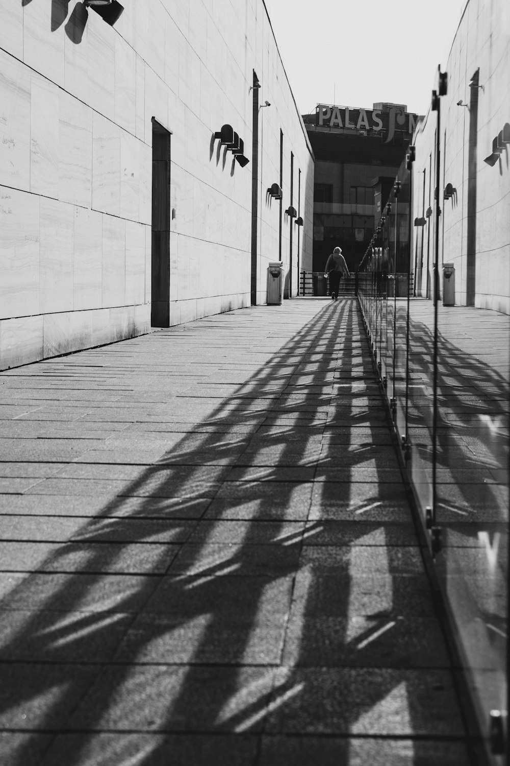 a black and white photo of a long walkway