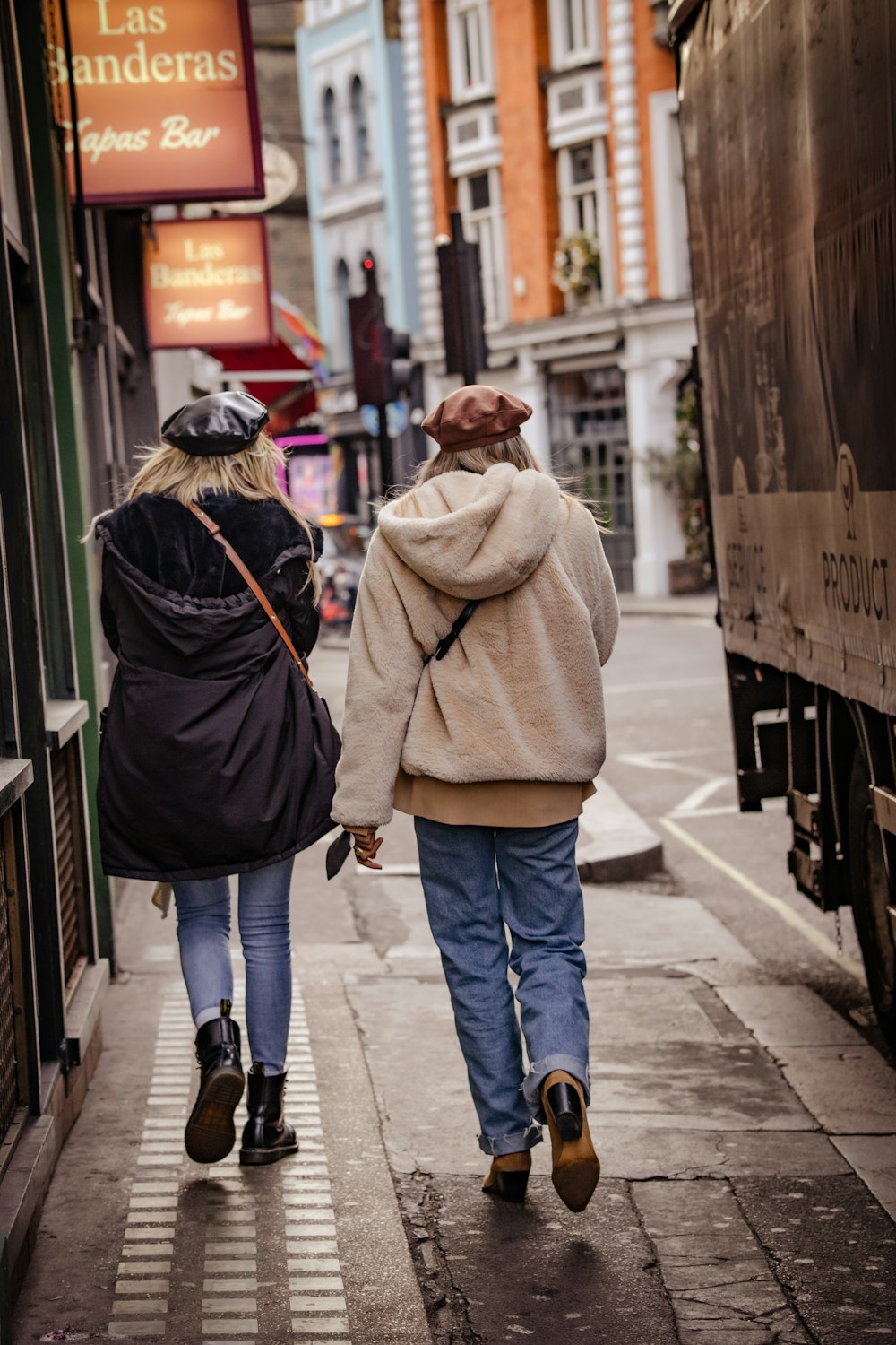 a couple of people walking down a street