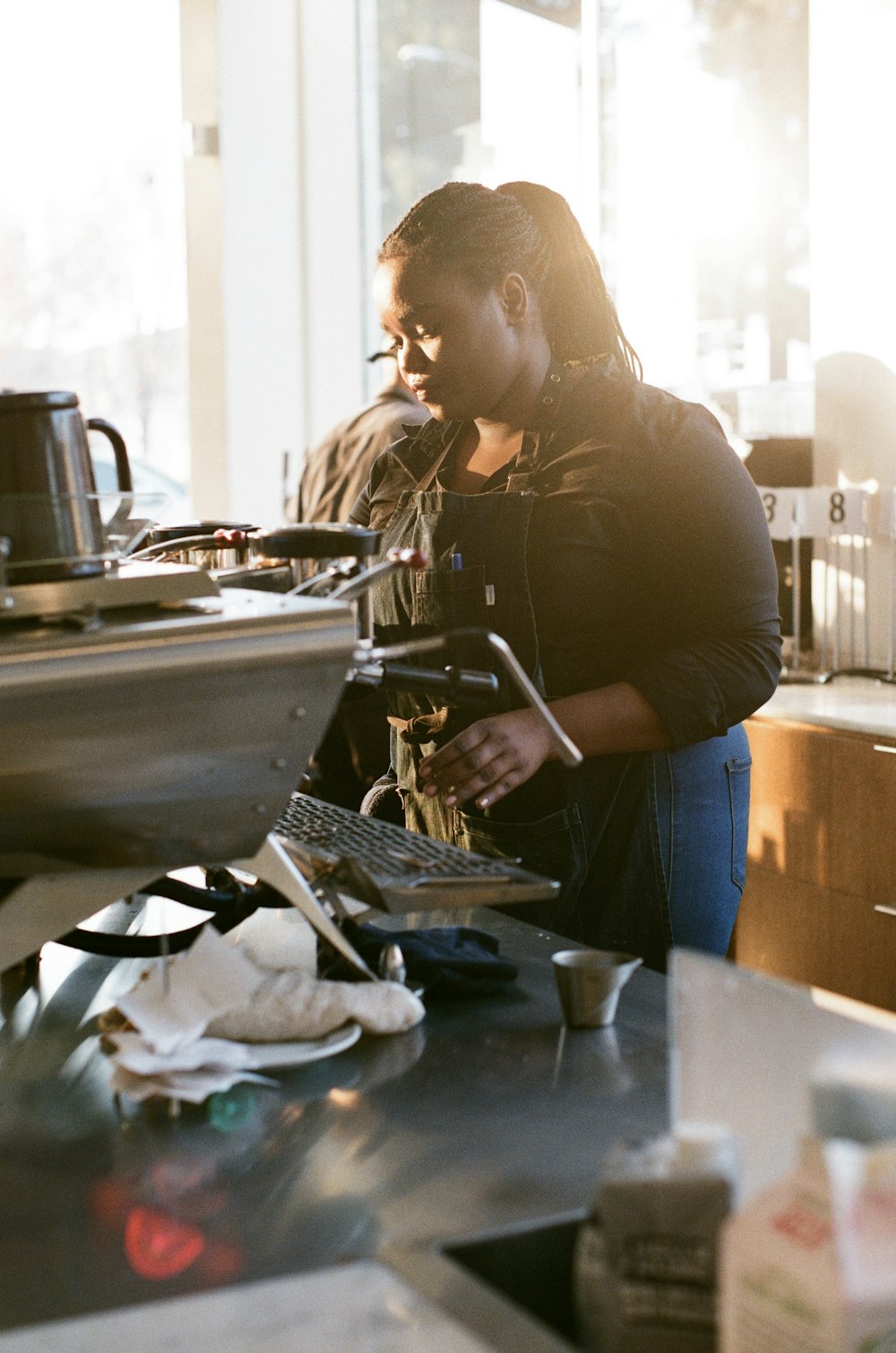 a woman standing in a kitchen next to a stove