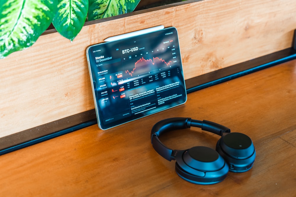 a pair of headphones sitting on top of a wooden table